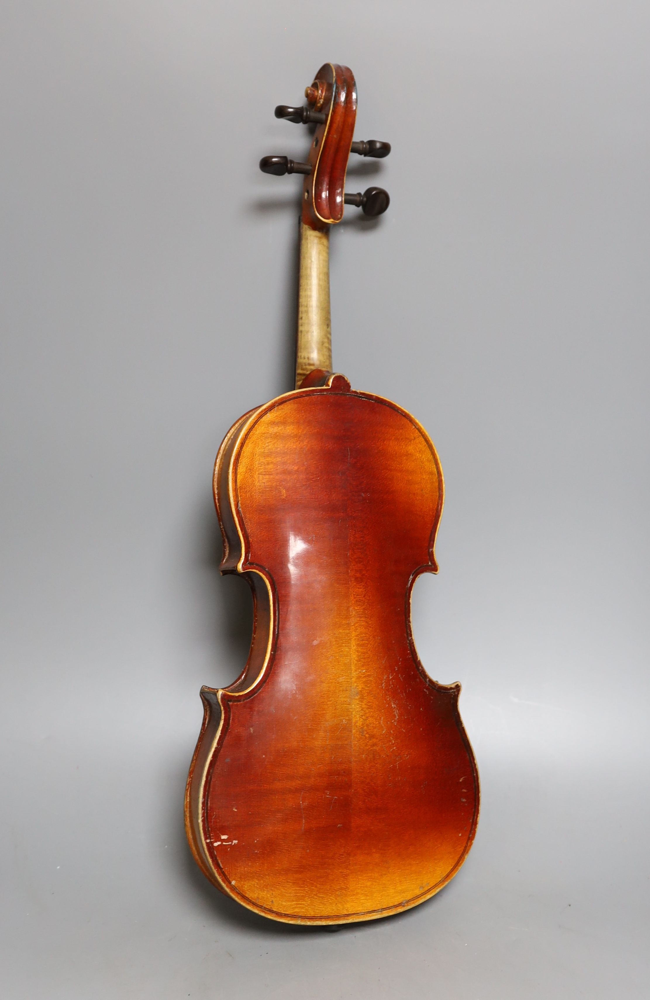 A cased 3/4 size violin, 55cms long.